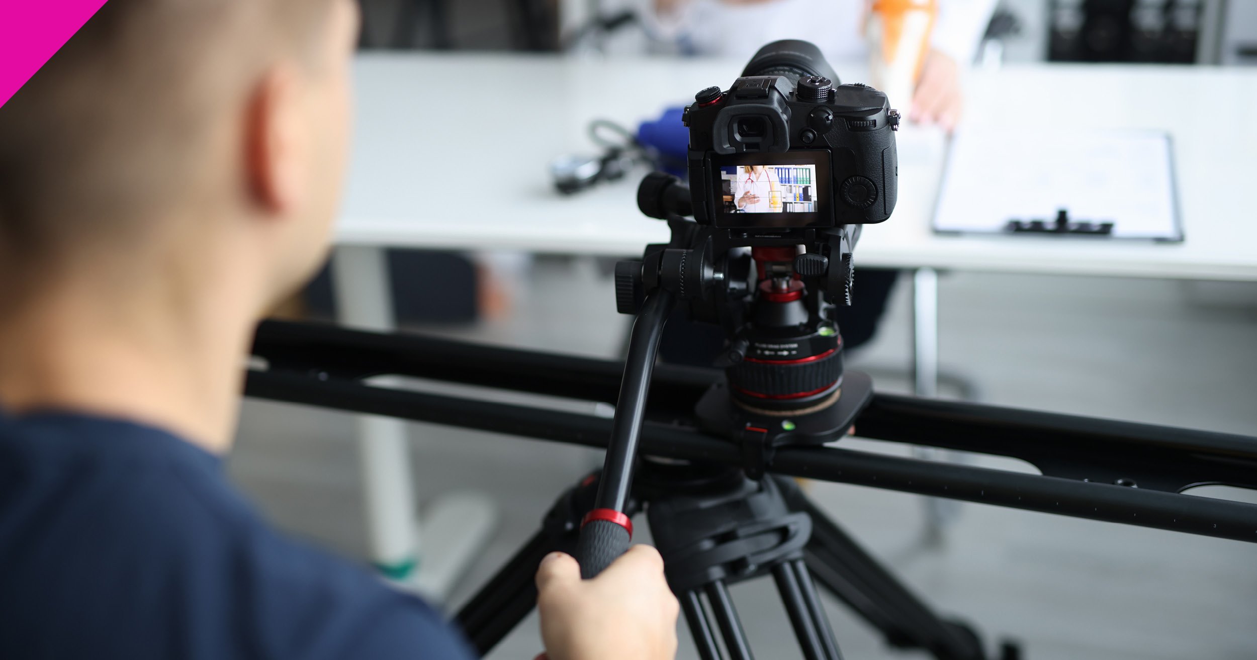 Man behind camera on tripod