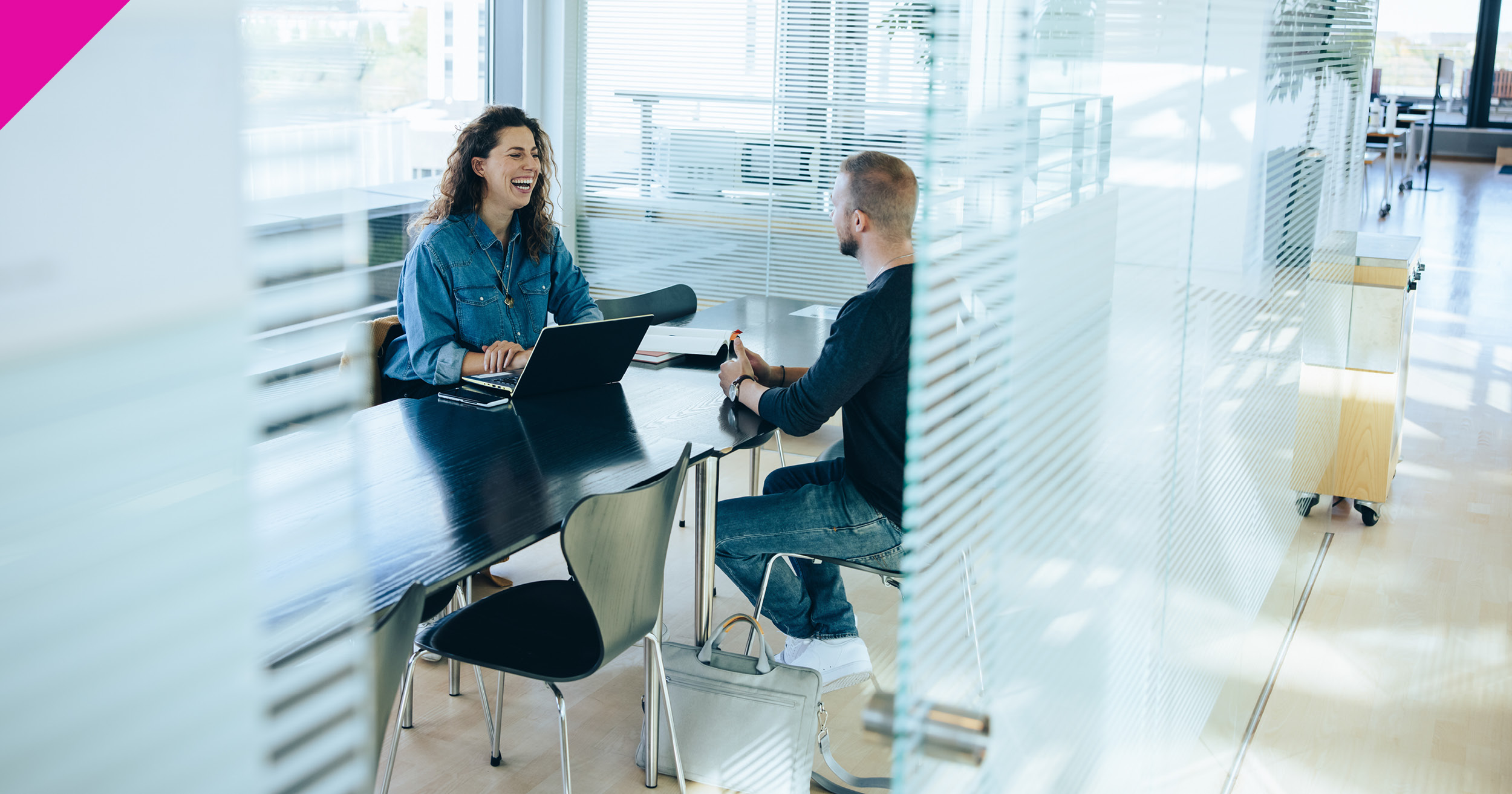 Woman and man sat in meeting room 