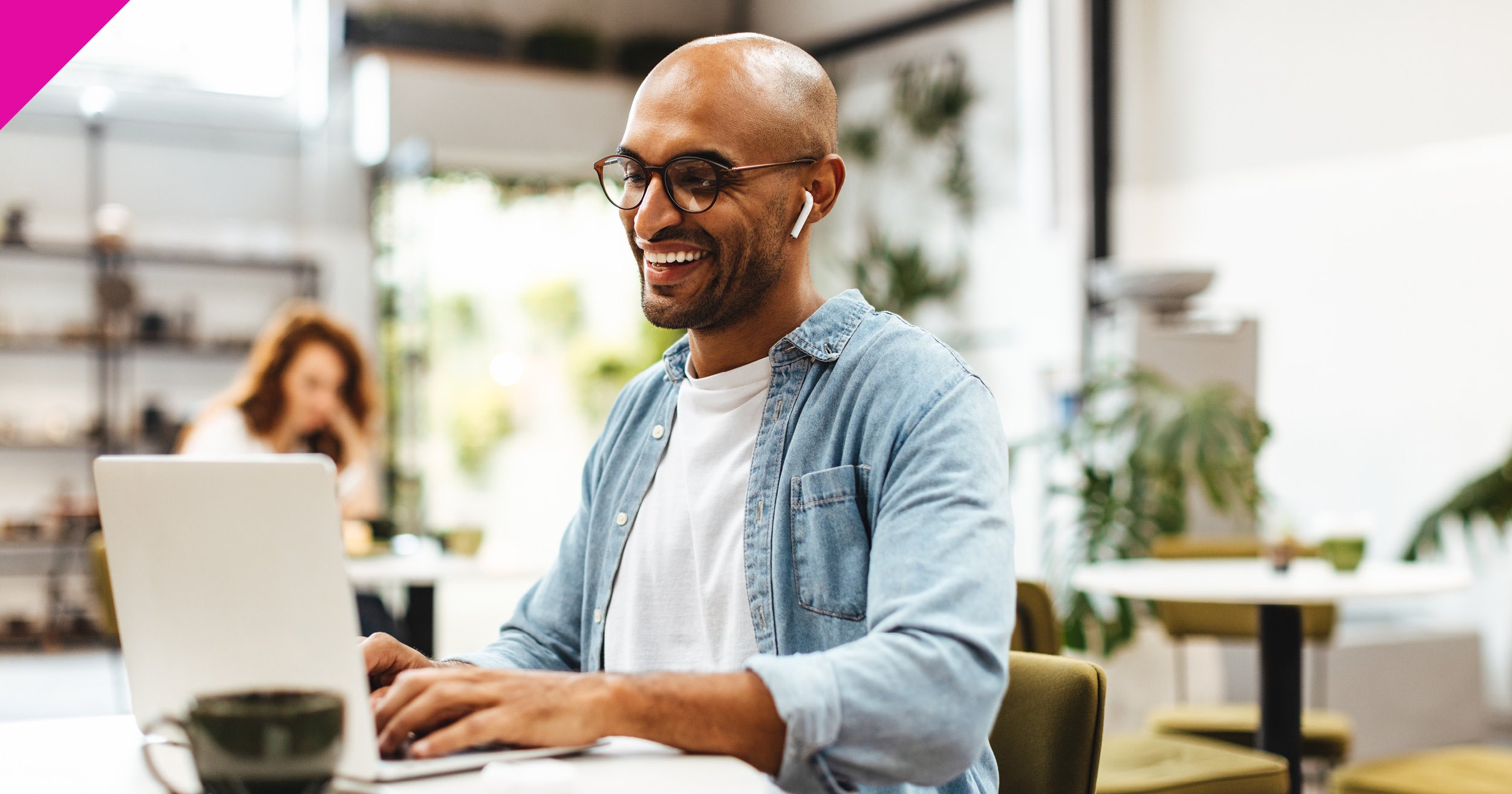 man sat at desk using laptop