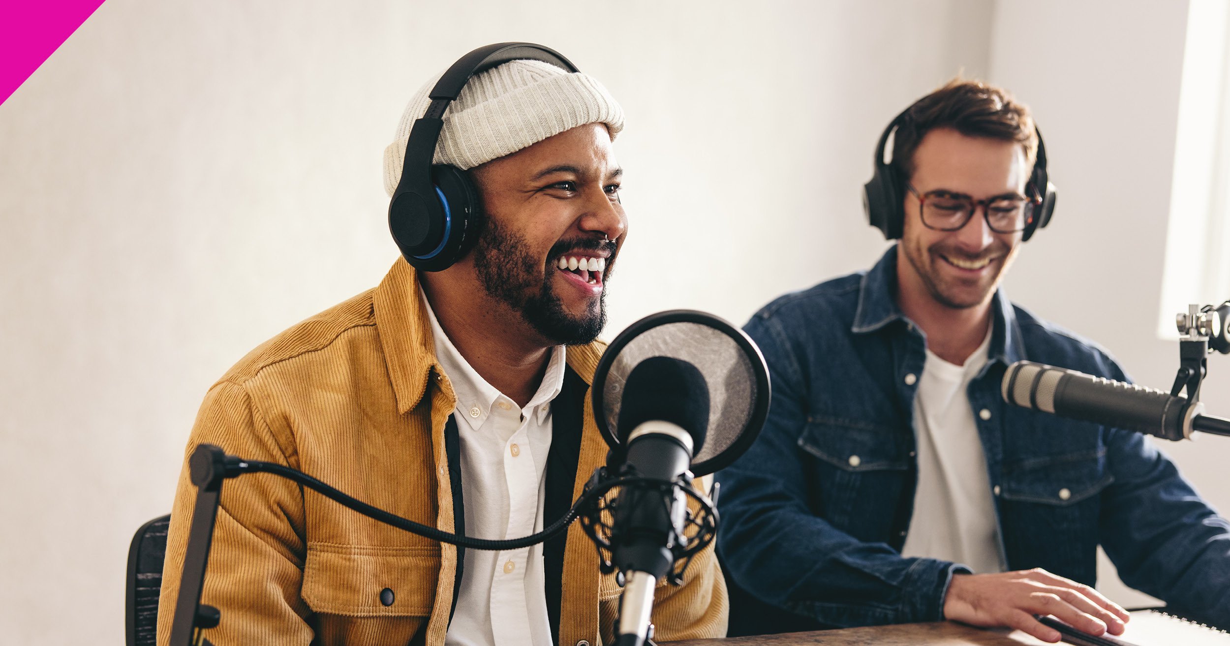 Two men sat together recording a podcast 