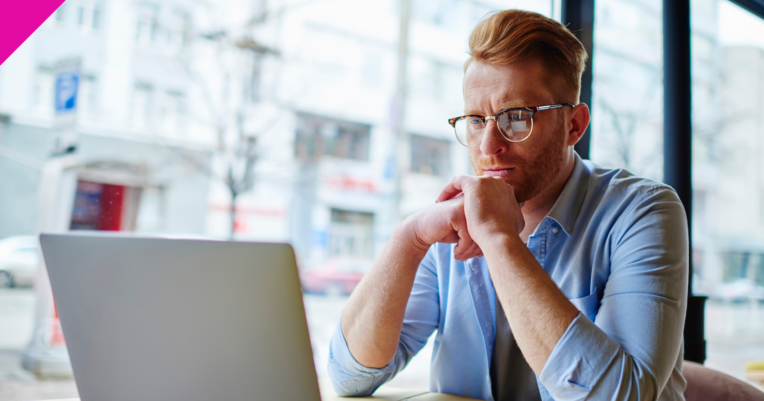 Man sat looking at laptop