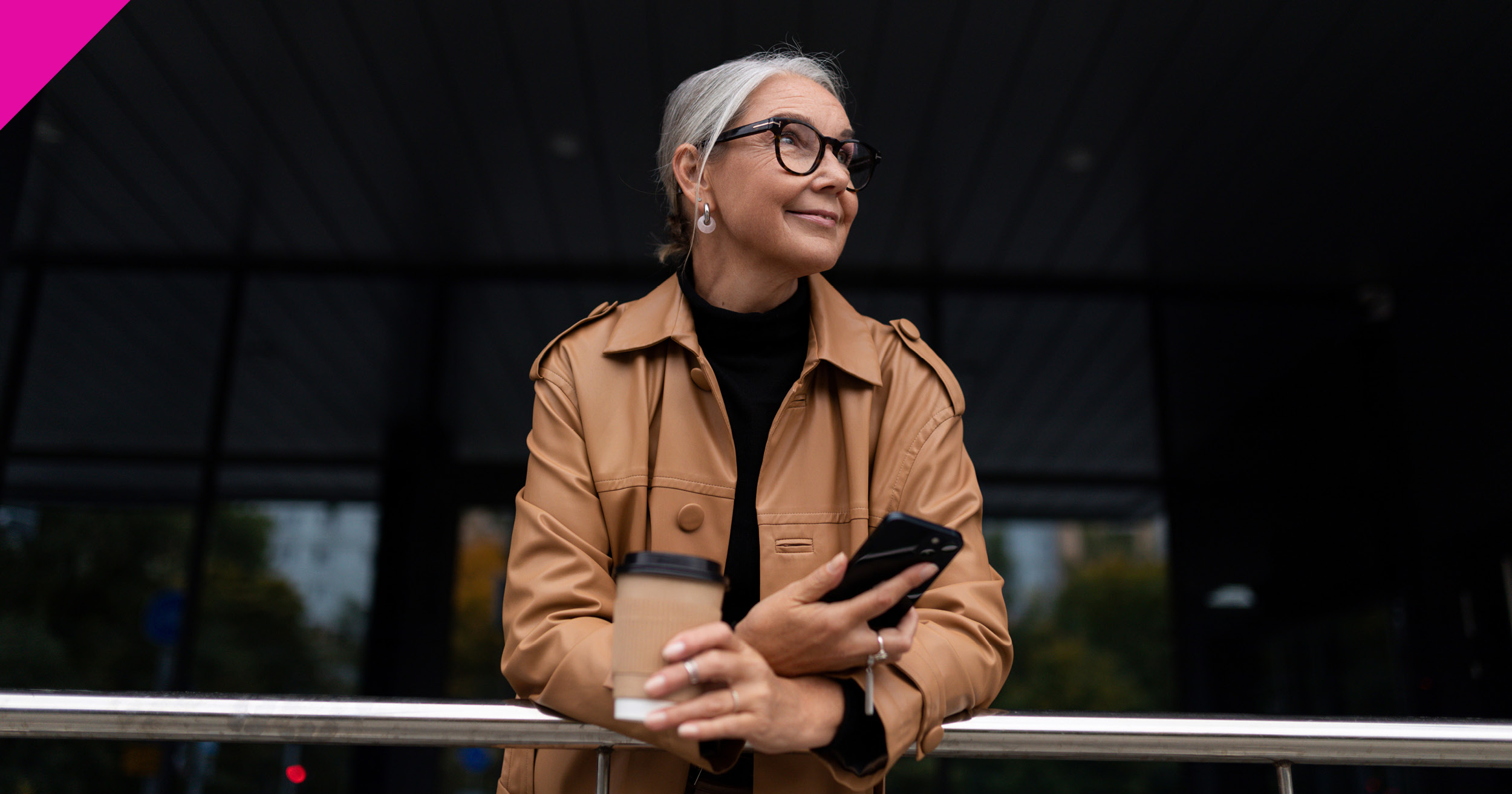 Woman stood outside holding phone