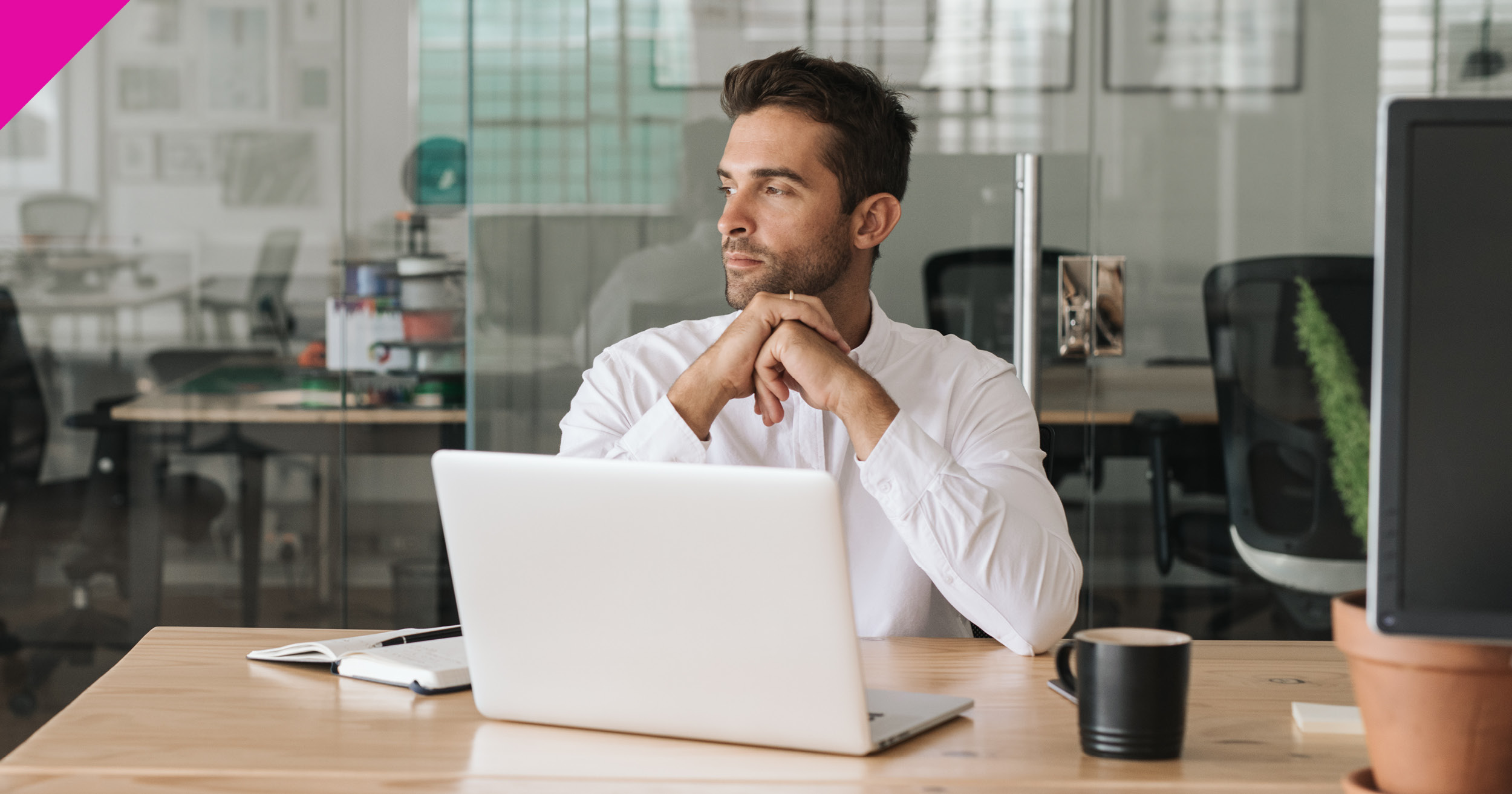 Man sat at desk with laptop