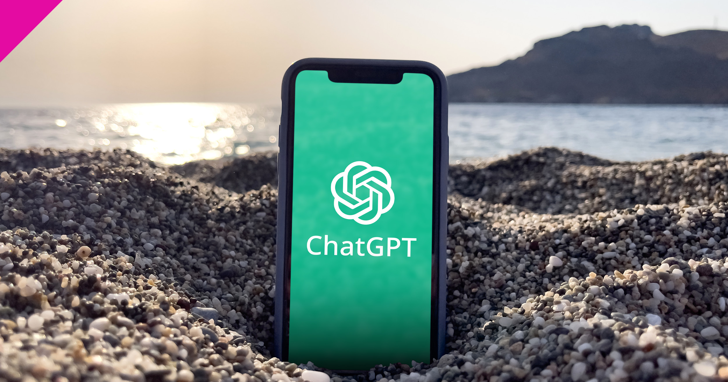Phone on beach with ChatGPT logo on screen